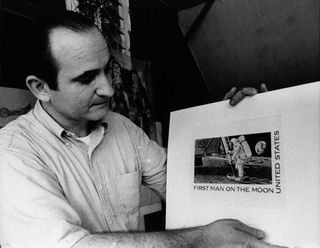 Artist Paul Calle holding the artwork for his 1969 "First Man on the Moon" U.S. postage stamp. 