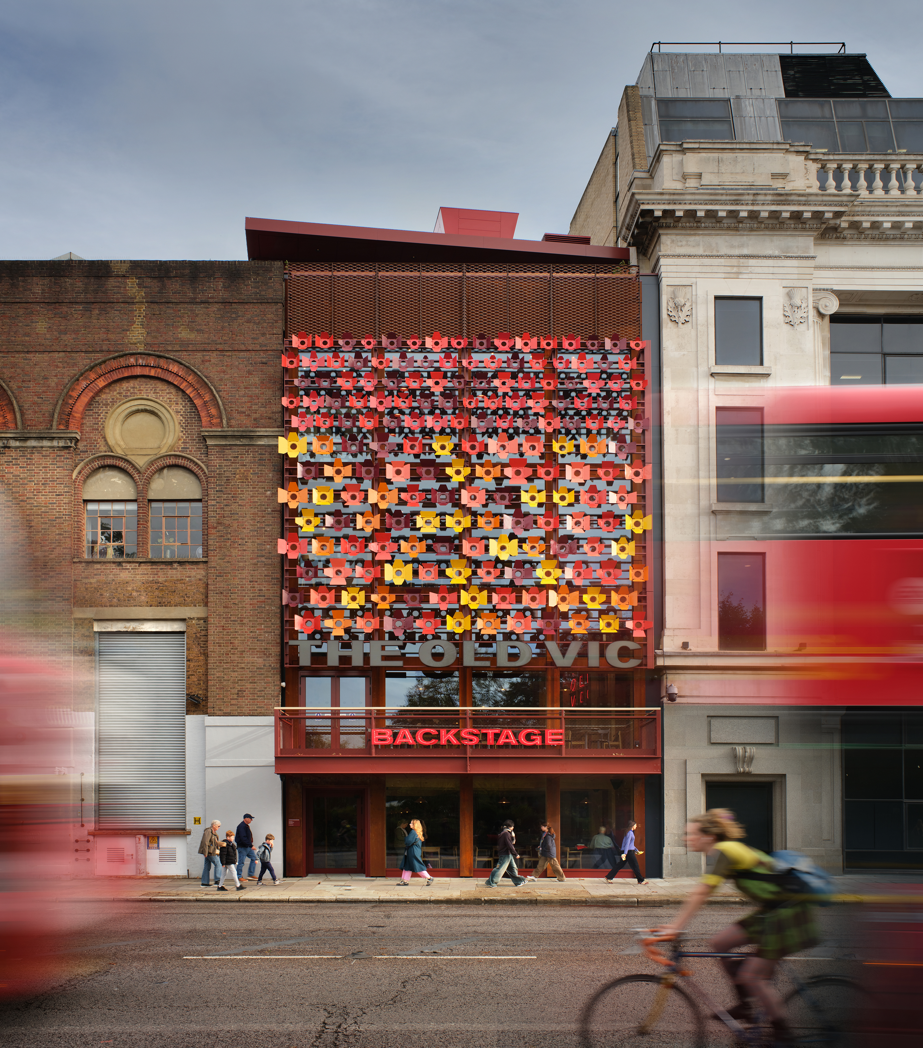Backstage at the Old Vic, colourful spaces in warm terracota colours in a timber framed building