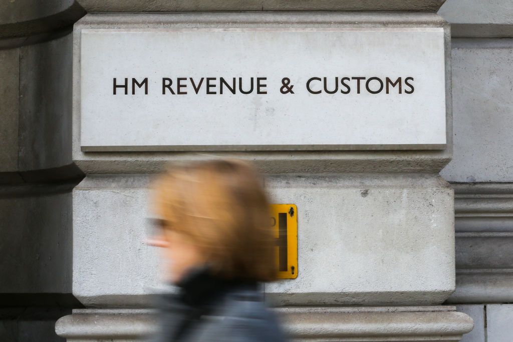 A person walks past the HMRC building.