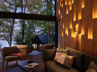 Inside the Muskoka Room, looking past the sleeping cabin to the lake beyond