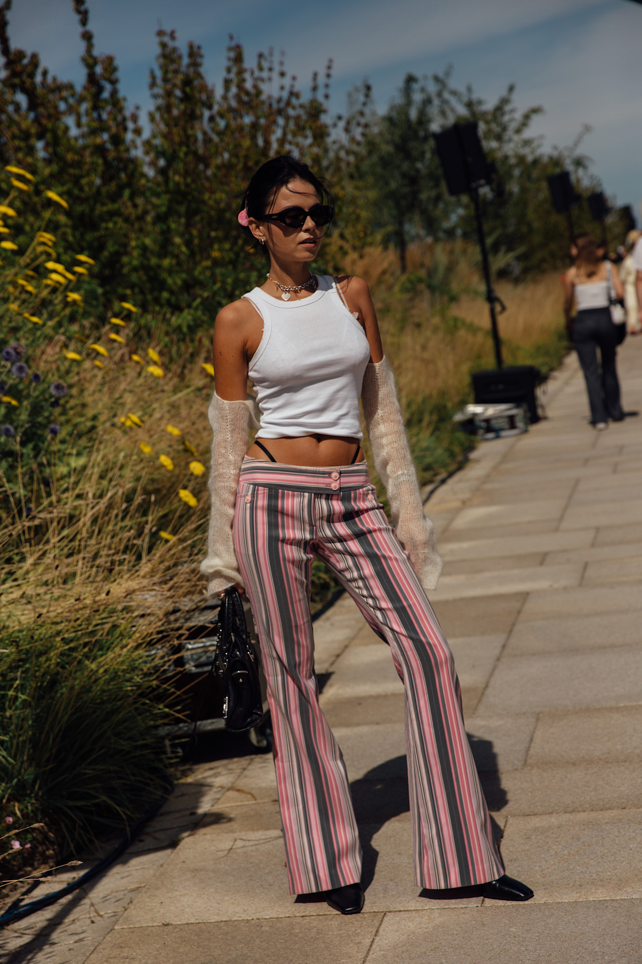 woman wearing a tank top with striped pants
