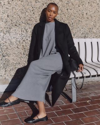 @_marisamartins_ wearing a grey knit dress and long coat