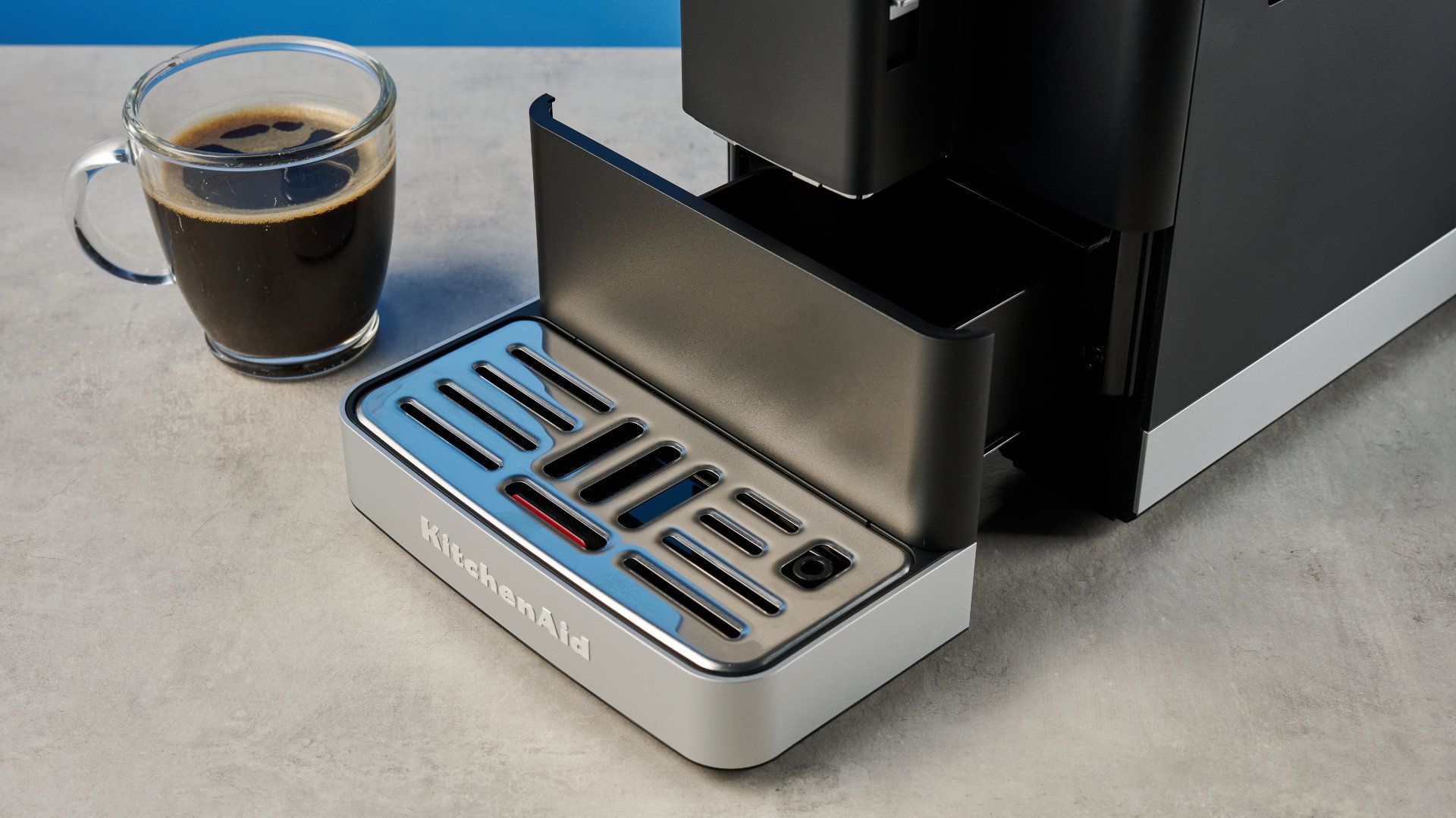 the kitchenaid kf3 superautomatic coffee machine photographed against a blue tom's guide background
