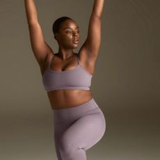 woman wearing an adanola back in stock sports bra and leggings from the article
