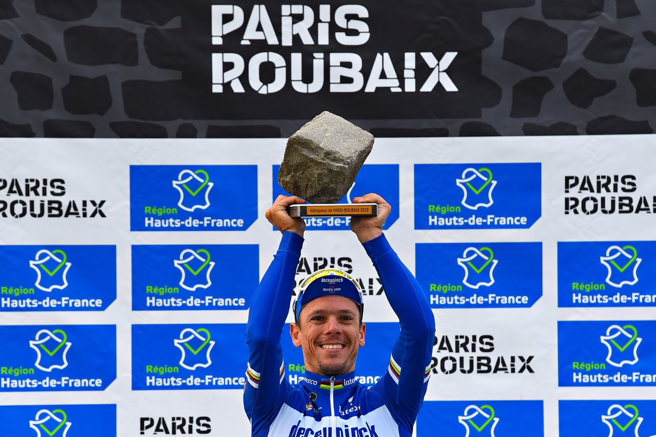 Philippe Gilbert lifts the famous cobblestone trophy