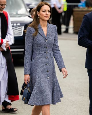 Kate Middleton wearing a grey midi coat dress