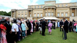 The Queen greets guests at a Garden Party in Buckingham Palace