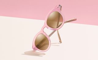A pair of sunglasses with pink frames