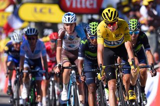 Nairo Quintana and Movistar teammate Alejandro Valverde flank Chris Froome as they cross the finish line in Culoz