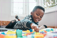 Shot of an adorable little boy playing with toys at home