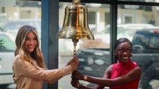 Chrishell Stause and Chelsea Lazkani ringing the bell at The Oppenheim Group office in Selling Sunset season 8.