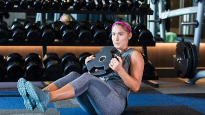 Woman doing an ab exercise in a gym.