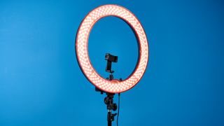 Neewer RL-18 ring light photographed in front of a blue background. 