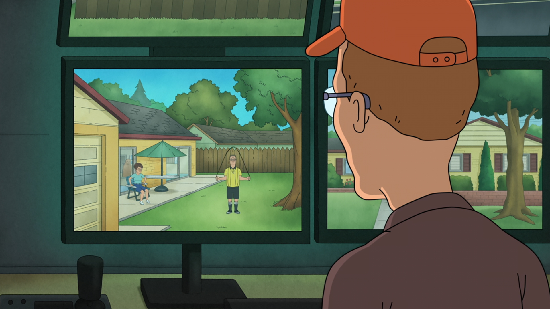 Dale Gribble watching Hank practice refereeing from a secret security monitor in his basement