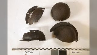 Fragments of iron shield bosses found at the site of the Gokstad ship. The boss protected the hand holding the shield, which gripped a wooden handle across it.