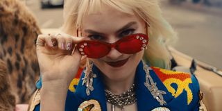 Harley Quinn wearing sunglasses before eating breakfast sandwich