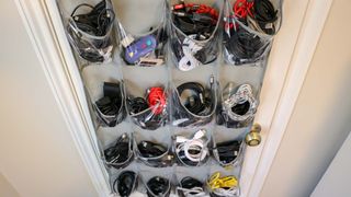 Cables organized by type in an over-the-door shoe rack