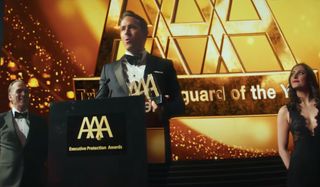 Ryan Reynolds accepts an award with excitement in The Hitman's Wife's Bodyguard.