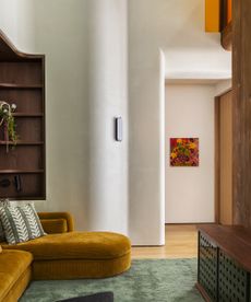 living room with limewash walls and yellow sofa
