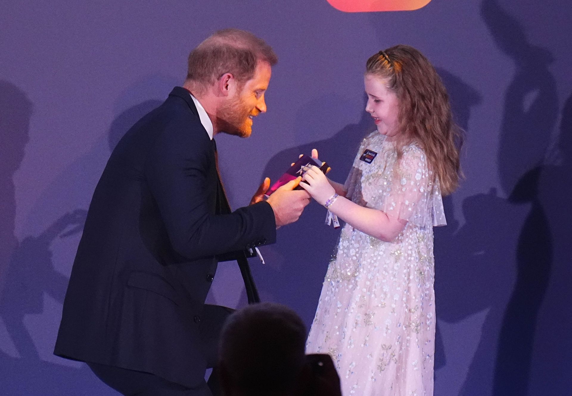Prince Harry handing an award to Margot Jones-Billington at the WellChild Awards