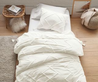 Minimalist bedroom with white bedding and small accents