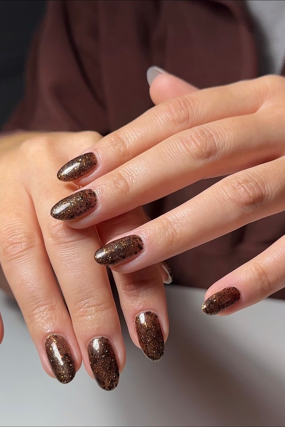 A shimmery chocolate brown nail polish.