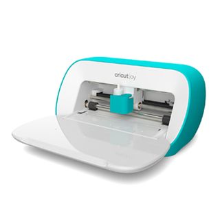 The best Cricut machines; a small green and white craft machine with its lid and draw open so you can see its cutting blade