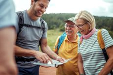 Family looking at a map while hiking in a National Park