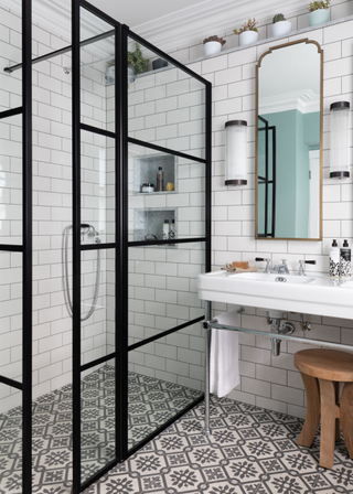 porcelain printed tiles on the floor of a bathroom with a large shower, and white subway tiles on the walls