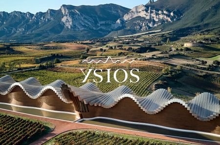 Ysios winery with mountains in the background and Ysios logo in white over the top