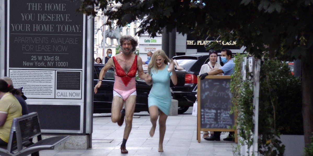 Borat and Tutar run through the streets following her interview with Rudy Giuilani in &#039;Borat 2&#039;