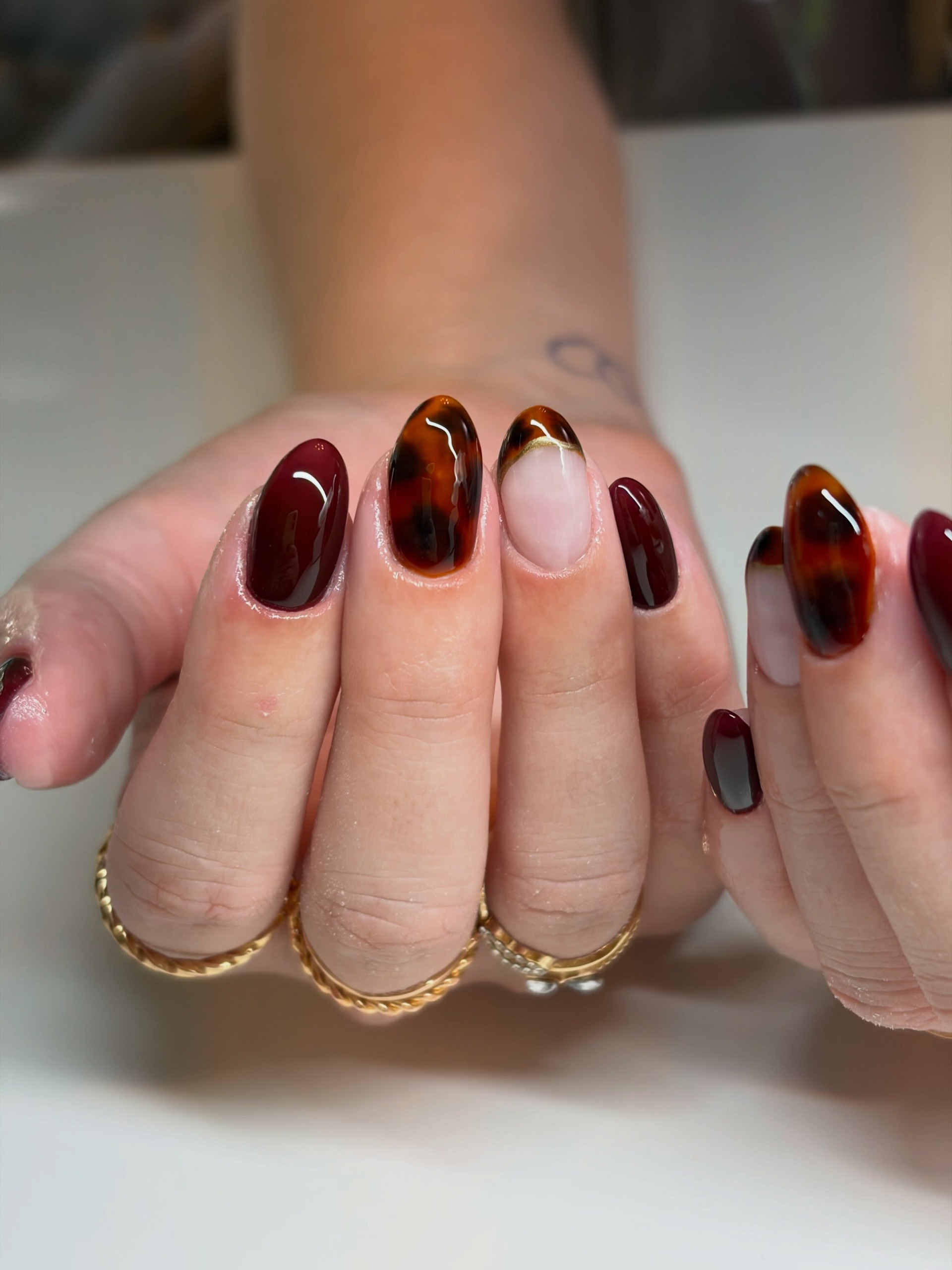 tortoise shell nails and french with gold and gold rings