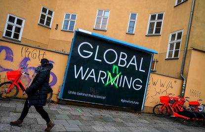 A sign telling people to believe in the science behind global warming.