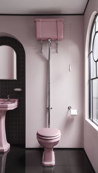 pink toilet and sink in downstairs cloakroom