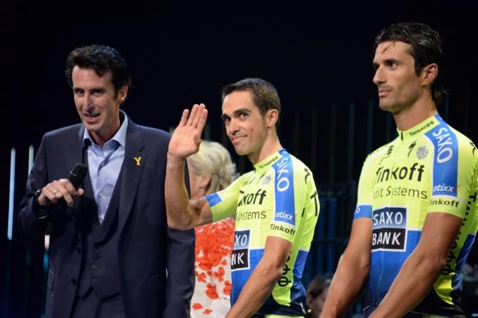A fluro Alberto Contador gives the crowd a wave