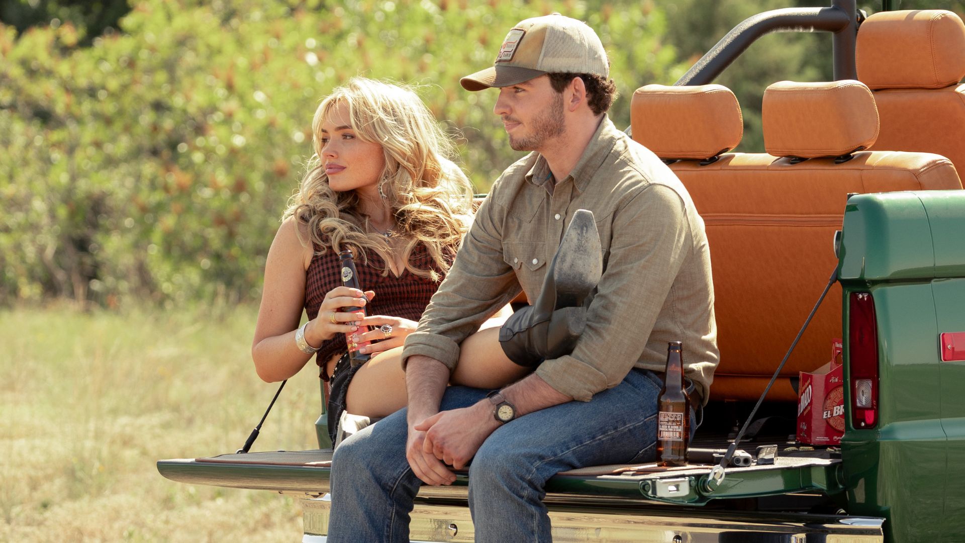 Oreana and Carter drinks beers on a pickup truck