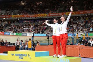 Sophie Unwin and pilot Georgia Holt react as they pose with two bronze medals lent by other athletes