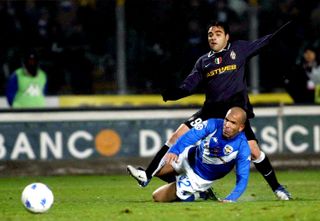 Brescia's Luigi Di Biagio tackles Juventus' Fabrizio Miccoli in a Serie A clash in March 2004.