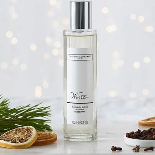 The White Compnay Home spray on a white background with sclices of orange and cloves to show the ingredients that make it one of the best-selling The White Company home scents