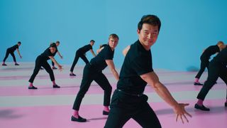 Simu Liu dancing in a scene from Barbie with the other Kens