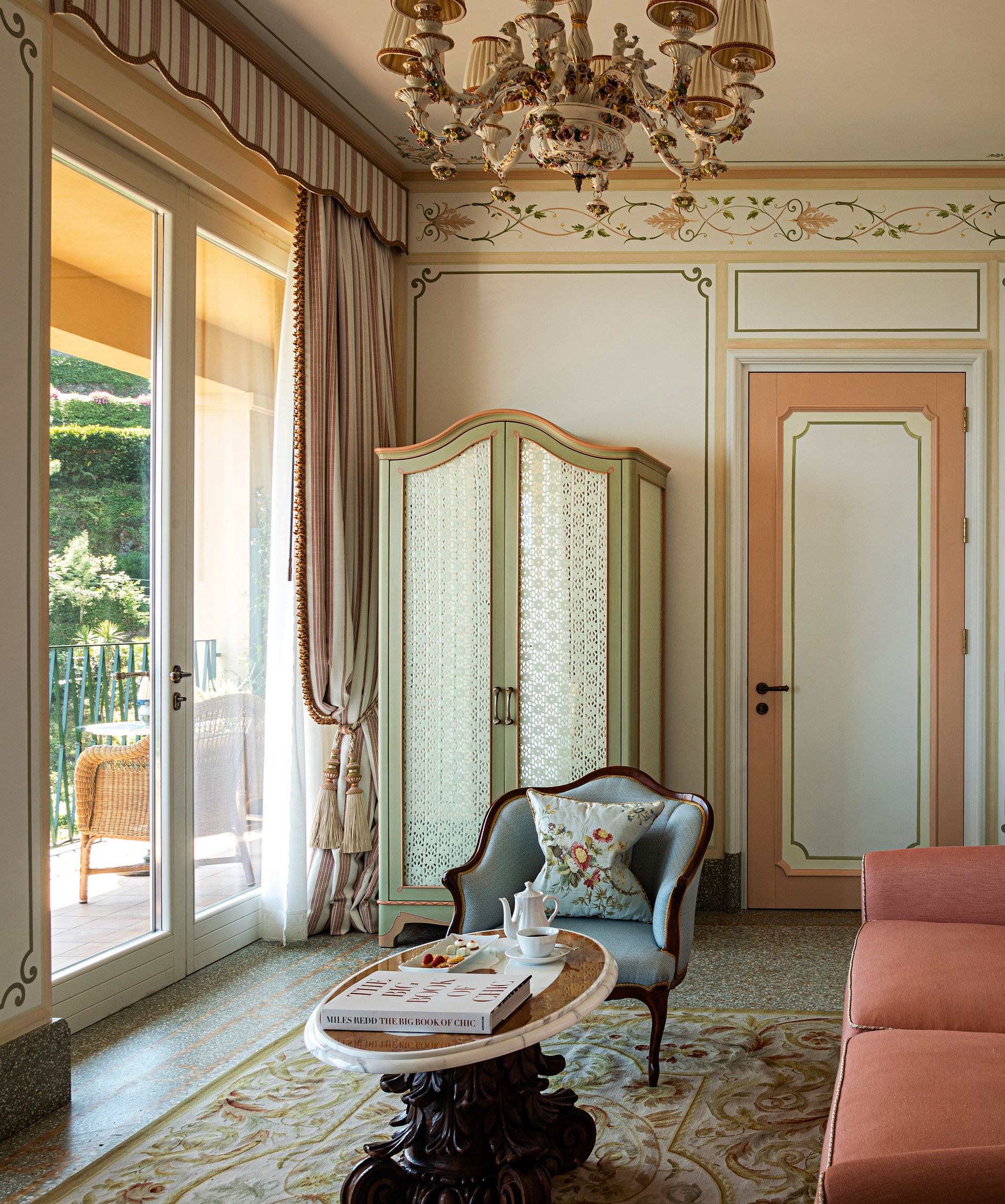 Bright living space with sofa, chair, wardrobe, window and balcony view