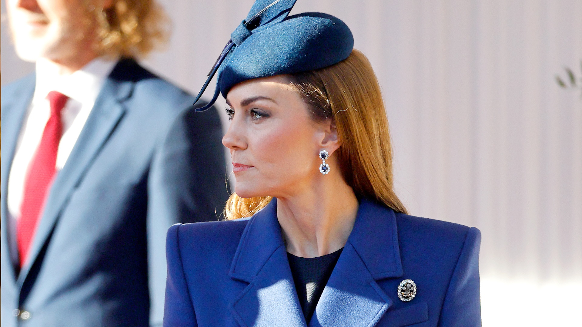 Kate Middleton wearing a blue coat and blue hat