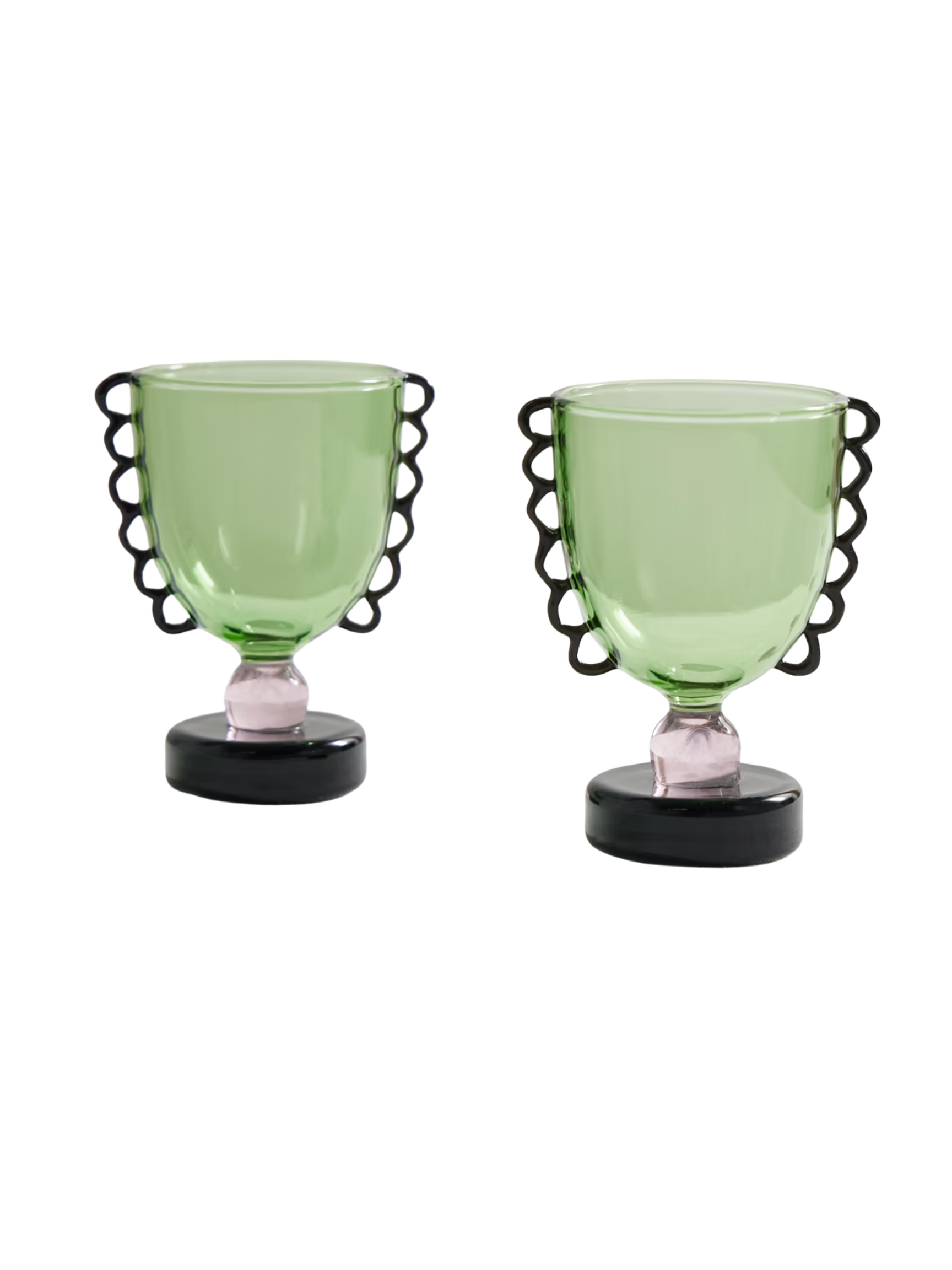 Two glasses in stained glass, inspired by ancient vases, feature a playful silhouette with an external, handle-like motif in green, a pink body, and a black base.