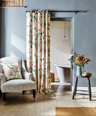 Bathroom curtain ideas with a floral cream curtain used over doorway to ensuite