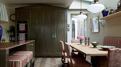 Green shaker kitchen with cupboard hat on pantry