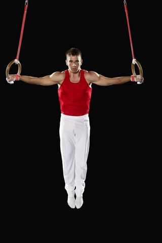 Gymnast on the rings apparatus.