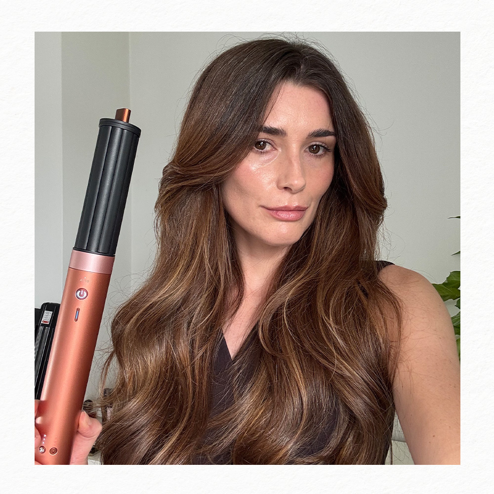 Eleanor holding the Dyson Airwrap Coandax2 with the curling barrel