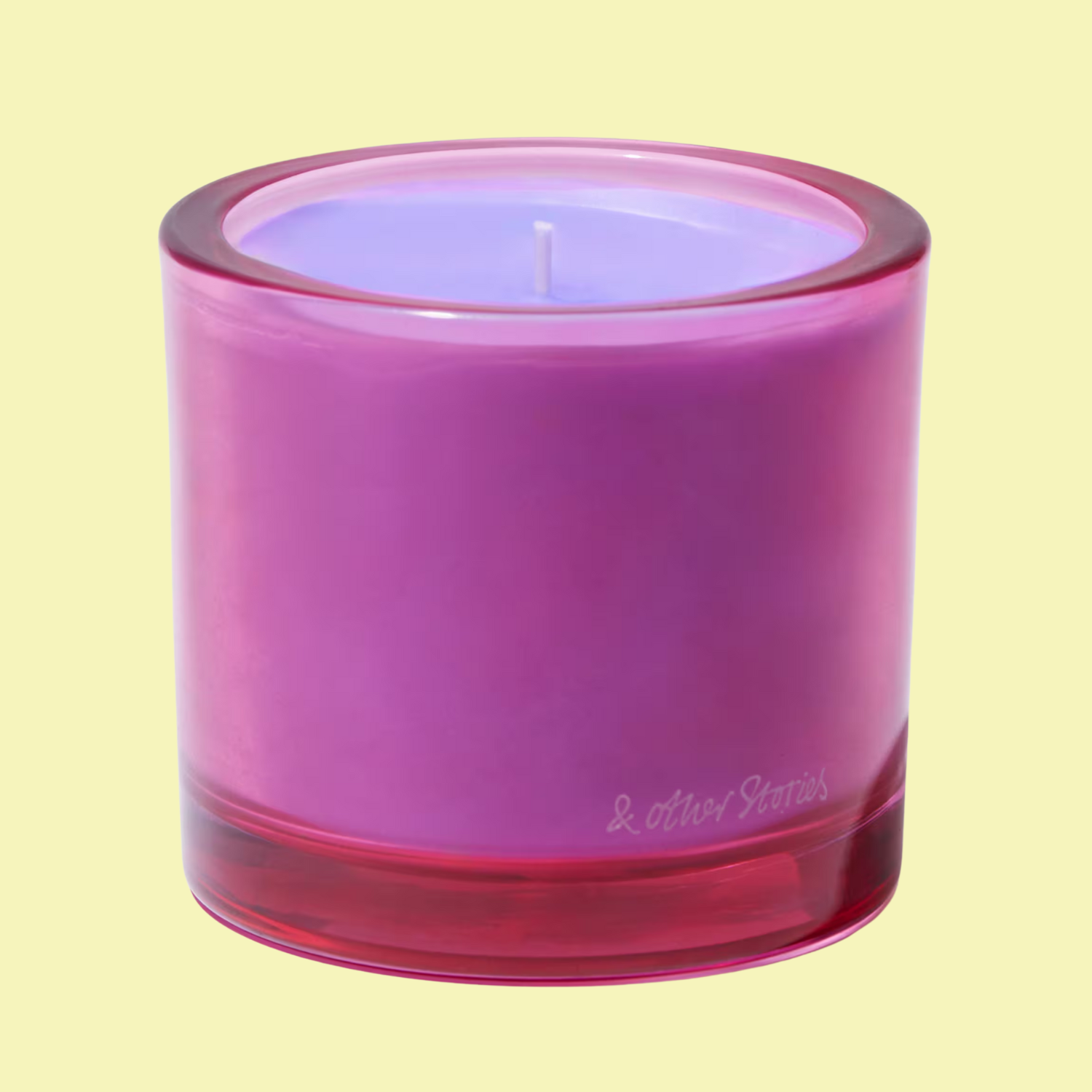 A purple candle in a pink glass from &amp;amp; Other Stories