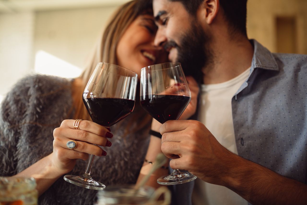 A couple drinking wine.