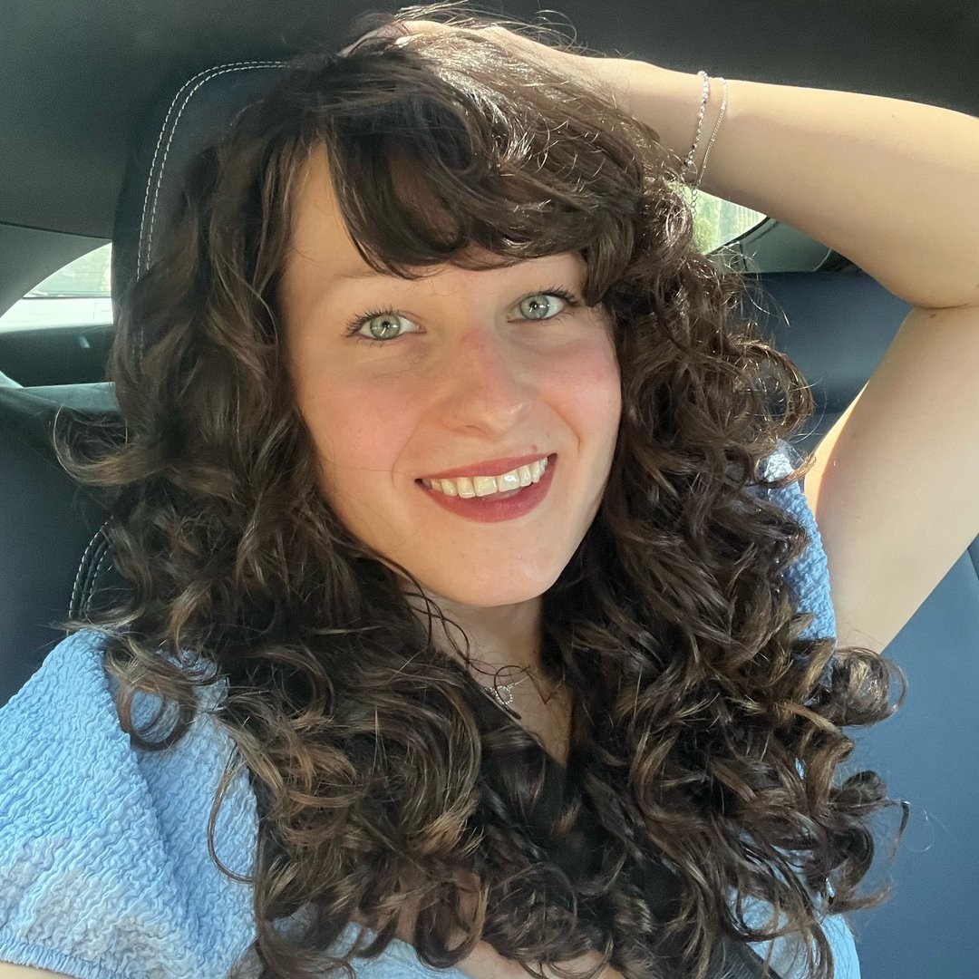 Rhea Blake, a curly hair specialist, takes a selfie and shows off her own curls.